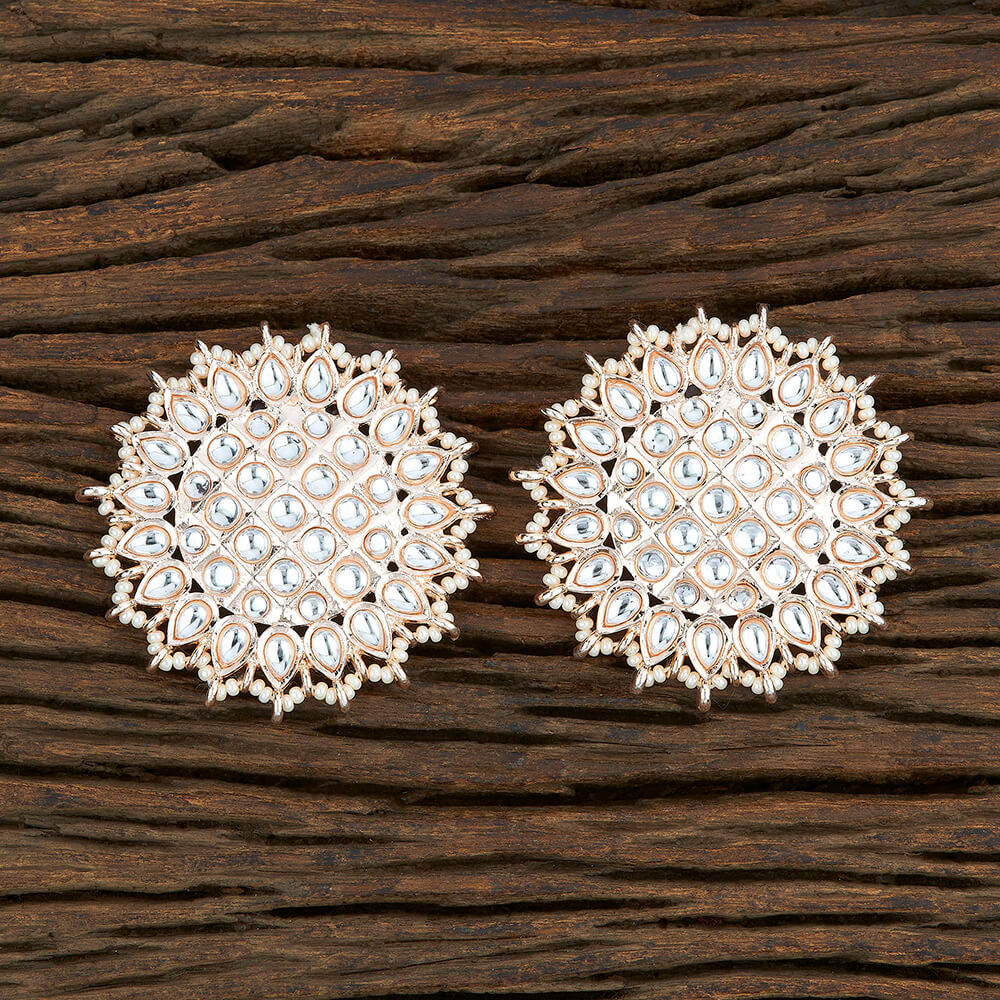 A pair of ornate circular gold-toned earrings embellished with clear stones