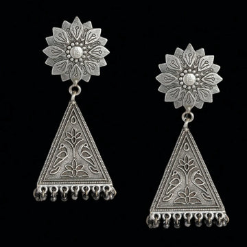 A pair of silver-toned traditional Indian jhumka earrings with intricate filigree work, featuring a floral stud and a dangling triangular pendant with hanging bead tassels, set against a solid black background.